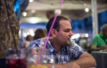 Young man talking in restaurant