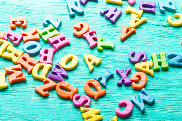 Multiple colored letters on wooden table