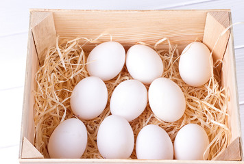 white eggs in a wooden box