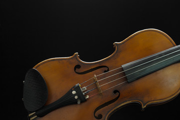 Fototapeta premium Old violin on a black background