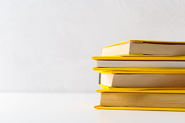  pile of paperback books on a table