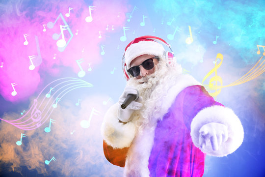 Santa Claus singing songs on blurred lights background. Christmas and New Year music