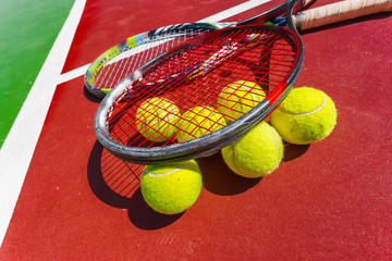 Tennis balls and racket on the grass court