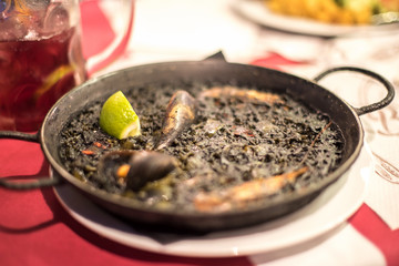 Black rice Paella recipe for two in traditional pan, recipe from Mediterranean