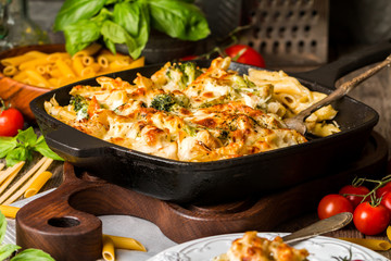 Baked pasta with broccoli, cauliflower, cheese and bechamel sauc