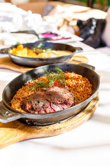 Beef stew, and buckwheat in a black cast iron skillet