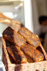 Rye and wheat bread with seeds lying on the counter on the street.