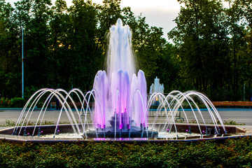 Glowing colored fountain in the city Park, in the summer evening.
