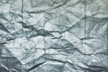 Crumpled silvery paper, texture background