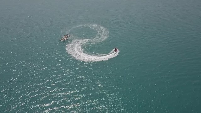 hydrocycle rides around the catamaran in the Black sea viewing from drone in slow motion