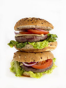 Hamburger meat and vegetables on white background