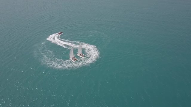 hydrocycle rides around the catamaran in the Black sea viewing from drone in slow motion