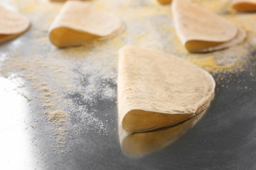 Yummy unleavened tortillas on metal kitchen table