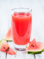 Wooden table with Watermelon Smoothie (selective focus)