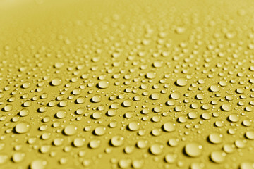Water drops on yellow surface