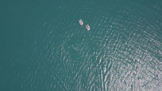 hydrocycle rides around the catamaran in the Black sea viewing from drone in slow motion