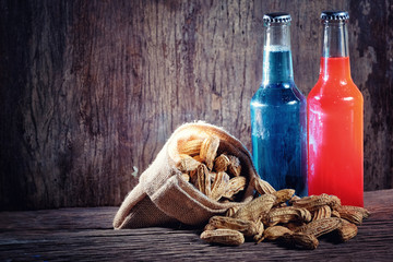 Boiled Peanuts and beer on wood background