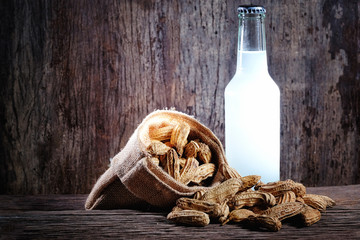 Boiled Peanuts and beer on wood background