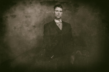 Fototapeta premium Antique wet plate photo of 1920s english gangster standing with cigarette.