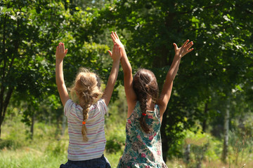 Two Little Girls With Her Hands Up