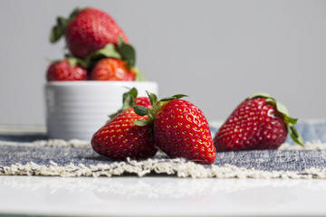 Juicy fresh strawberries in a white bowl