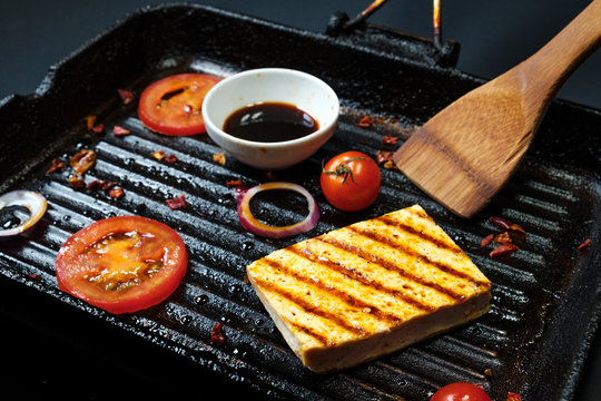ofu on the grill on the table on a black background, view from the top.