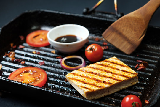ofu on the grill on the table on a black background, view from the top.