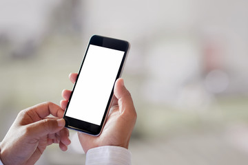 Man using smartphone on blur background. Blank screen smartphone for Graphic display montage.