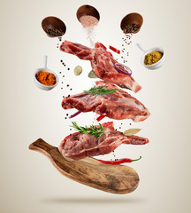 Flying raw pork steaks with ingredients, food preparation concept