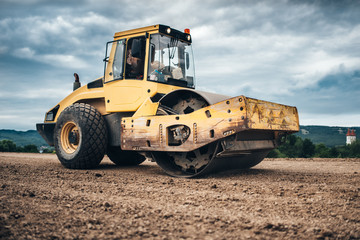 close up details of highway construction site - industrial machinery, vibratory soil compactor ...