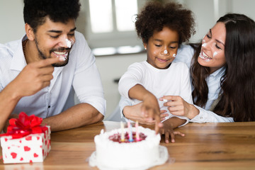 Happy family celebrating birthday of their child