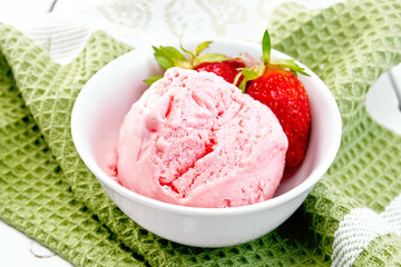 Ice cream strawberry with berries in bowl on green napkin