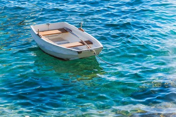 Small white wooden boat on Adriatic Sea