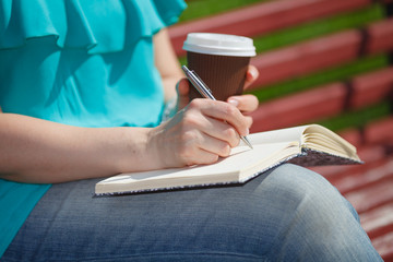 woman studying and writing in a park