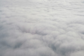 Aerial view from the plane of fluffy rain cloud in daytime - Cloudscape