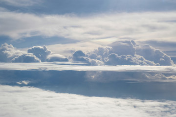 Aerial view from the plane of fluffy rain cloud in daytime - Cloudscape