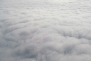 Aerial view from the plane of fluffy rain cloud in daytime - Cloudscape
