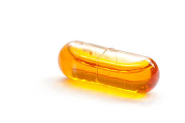 One orange pill on white background
