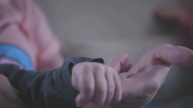 Young child holding his mother's finger. SLOW MOTION. HD, 1920x1080.