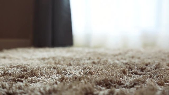 Synthetic carpet on the laminate in the home interior. Close-up