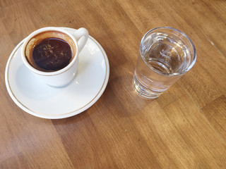 cup of coffee and water on table