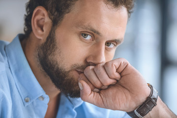 Obraz premium portrait of pensive handsome caucasian man looking at camera