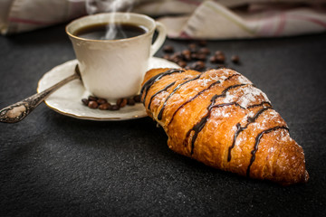 Croissant with chocolate and coffee
