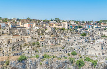 Fototapeta na wymiar panoramic view of typical stones house (Sassi di Matera) of Matera UNESCO European Capital of Culture 2019 under blue sky. Basilicata