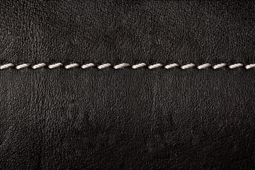 Black leather texture background with white seams