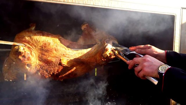 cooking lamb on a spit outdoors