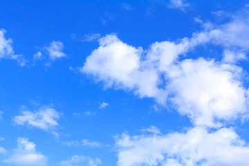 Blue sky background with white clouds, rain clouds on sunny summer or spring day.