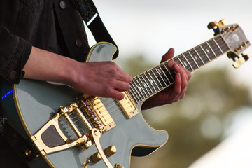 Obraz na płótnie Canvas Close up of man playing a guitar
