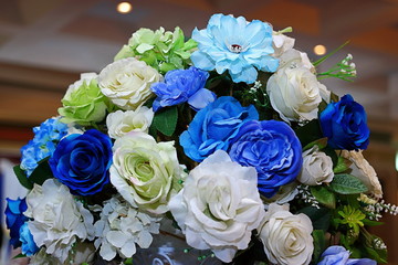 Artificial bouquet colorful of Rose flower decor in wedding ceremony. Selective focus and shallow depth of field.