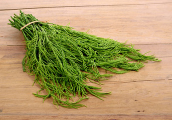 Climbing Wattle, Acacia, Cha-om on wooden table